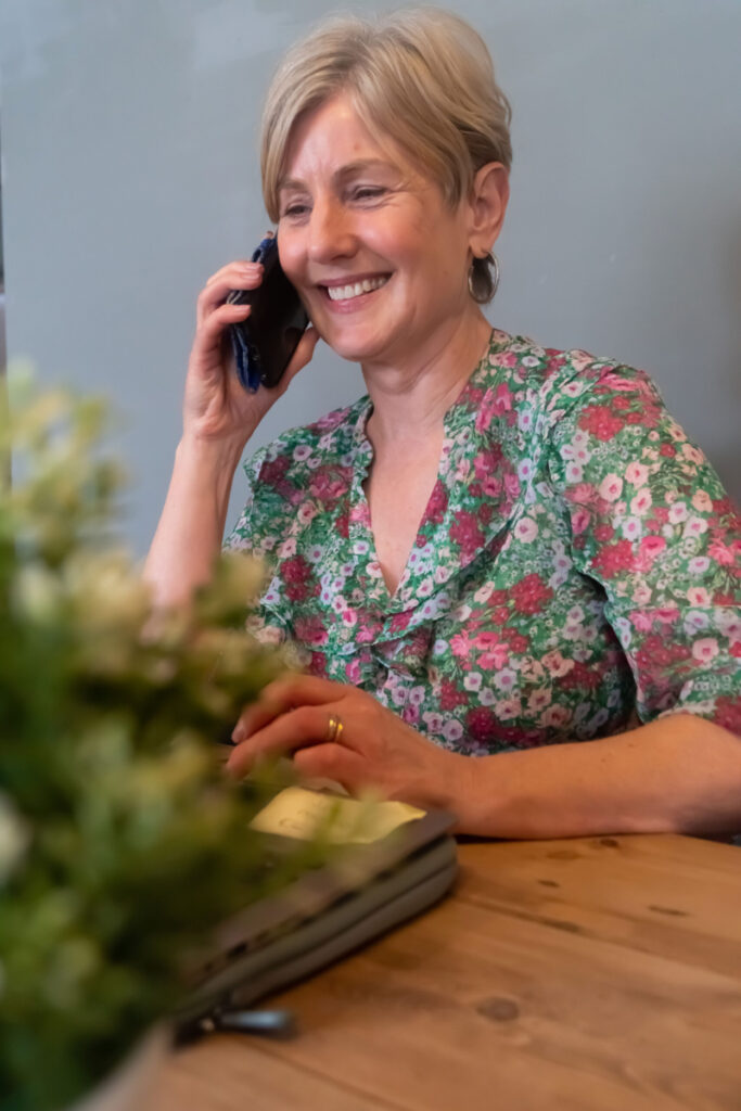 Picture of Gill on the phone and smiling