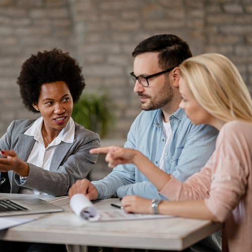 black-female-insurance-agent-using-computer-with-couple-consultations-office